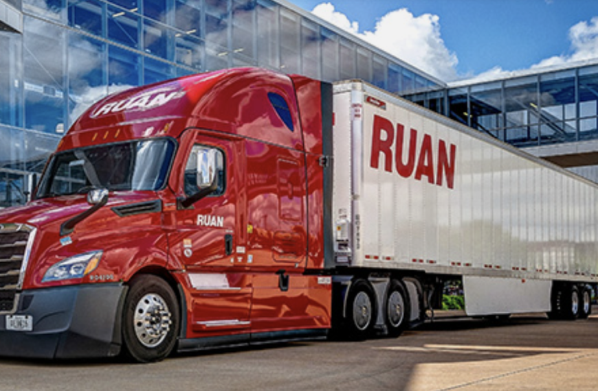 Ruan tractor-trailer in front of modern building