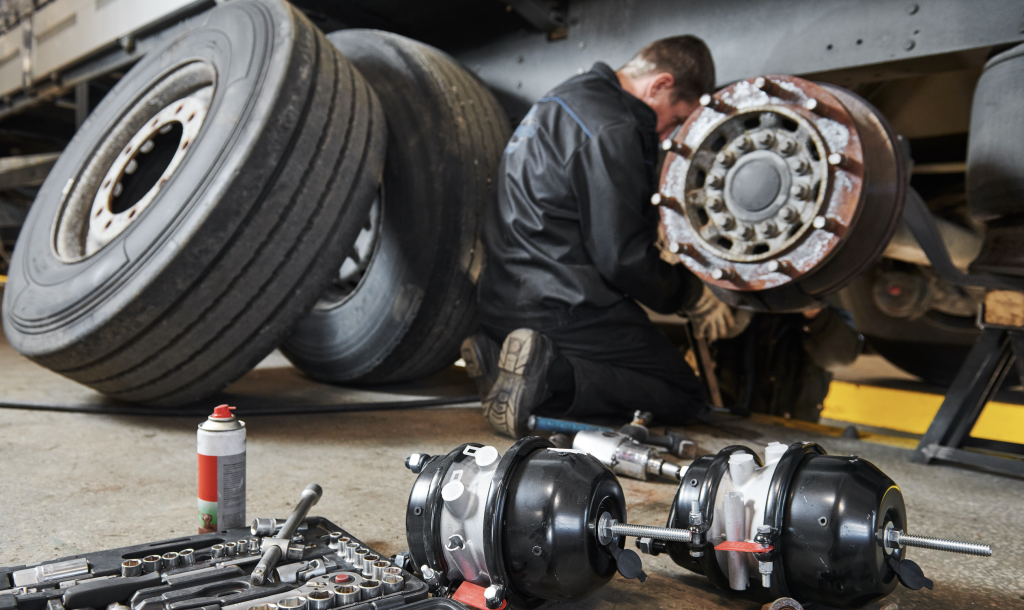 Professional technician works on big rig's brakes