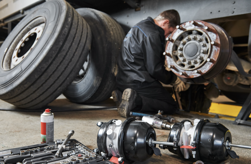 Professional technician works on big rig's brakes