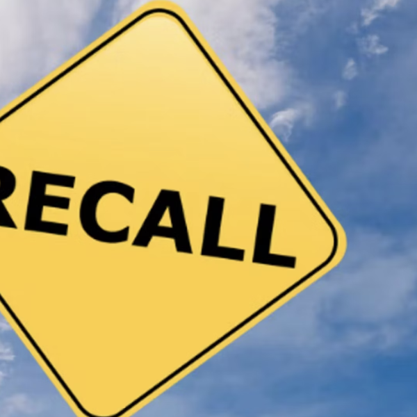 "Recall" on yellow highway sign against blue sky